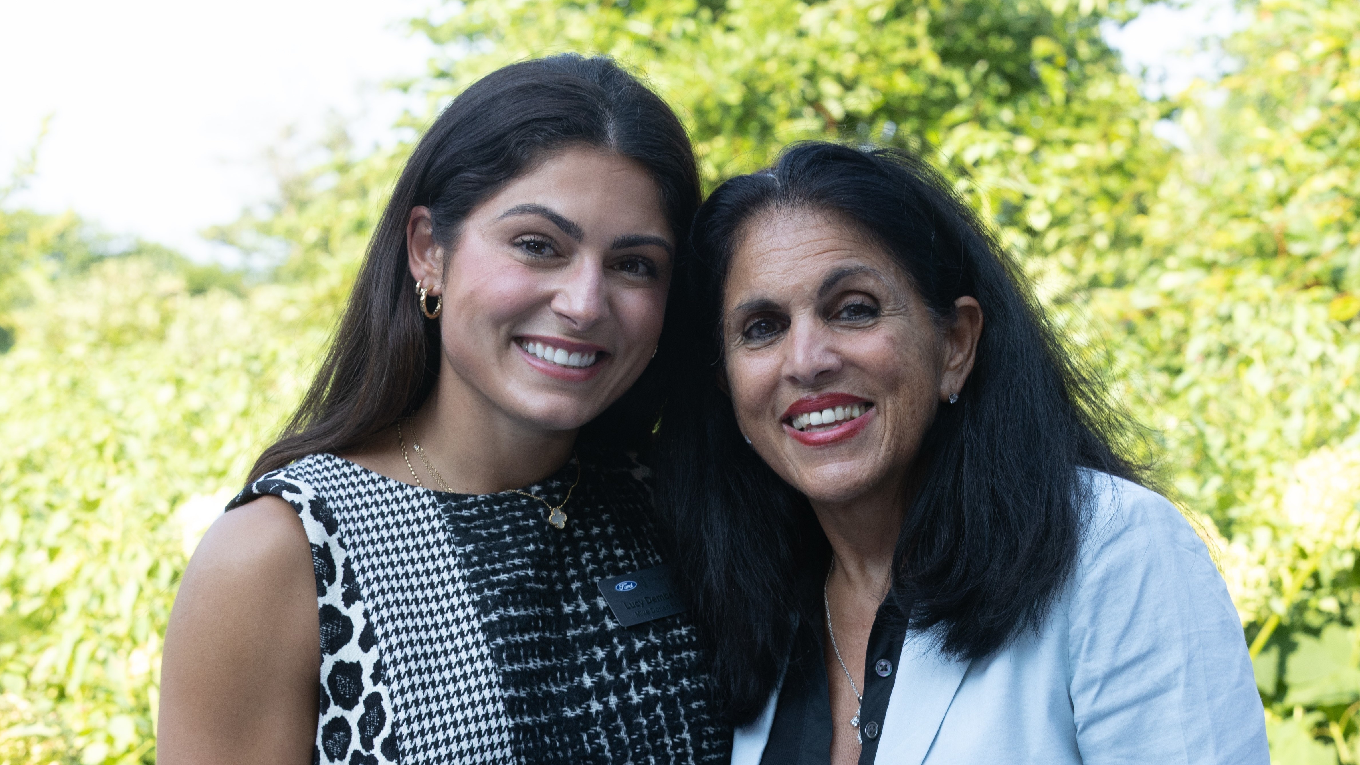 In the shadows of the historic Edsel and Eleanor Ford house in Grosse Pointe Shores, Michigan, Lucy Dembeck stands with her mother, Carolyn Dorian, as they celebrate her graduation from the Ford Rising Leaders program. 
